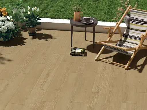 Terrace with wood-look floor, a lounge chair, side table with plant and magazine, surrounded by green plants and grass.