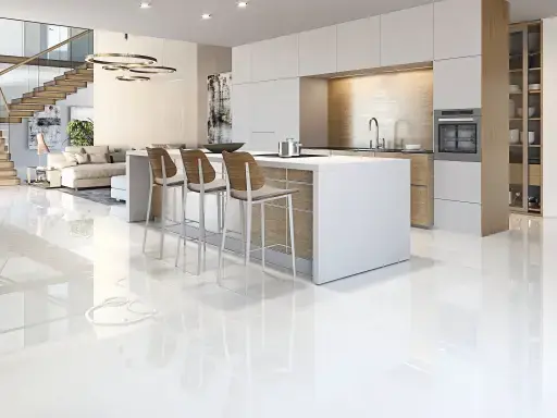 Sleek, modern open kitchen with glossy white floor, cooking island with bar stools and a view of a stylish living room and staircase.
